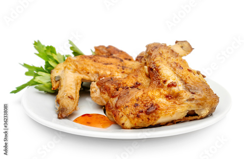 Plate with smoked chicken wings on white background.