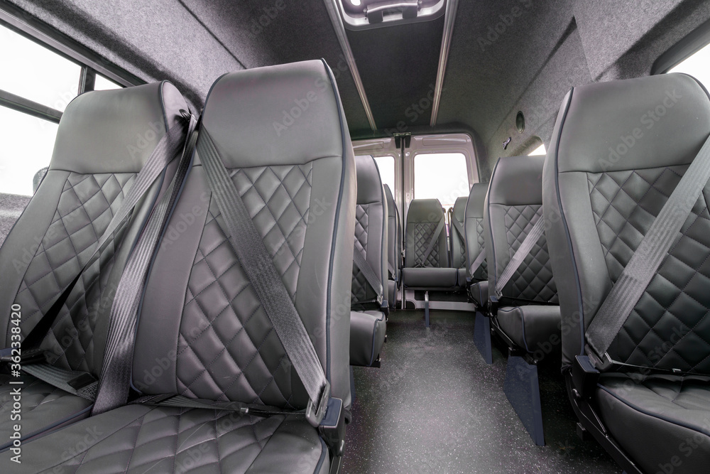 Interior of a van with many seats Interior of a van with many seats
