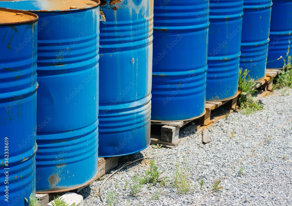 Big oil drums, blue. Chemical barrels in an open warehouse. Rusty barrels. Barrel for oil Big oil drums, blue. Chemical barrels in an open warehouse. Rusty barrels. Barrel for oil