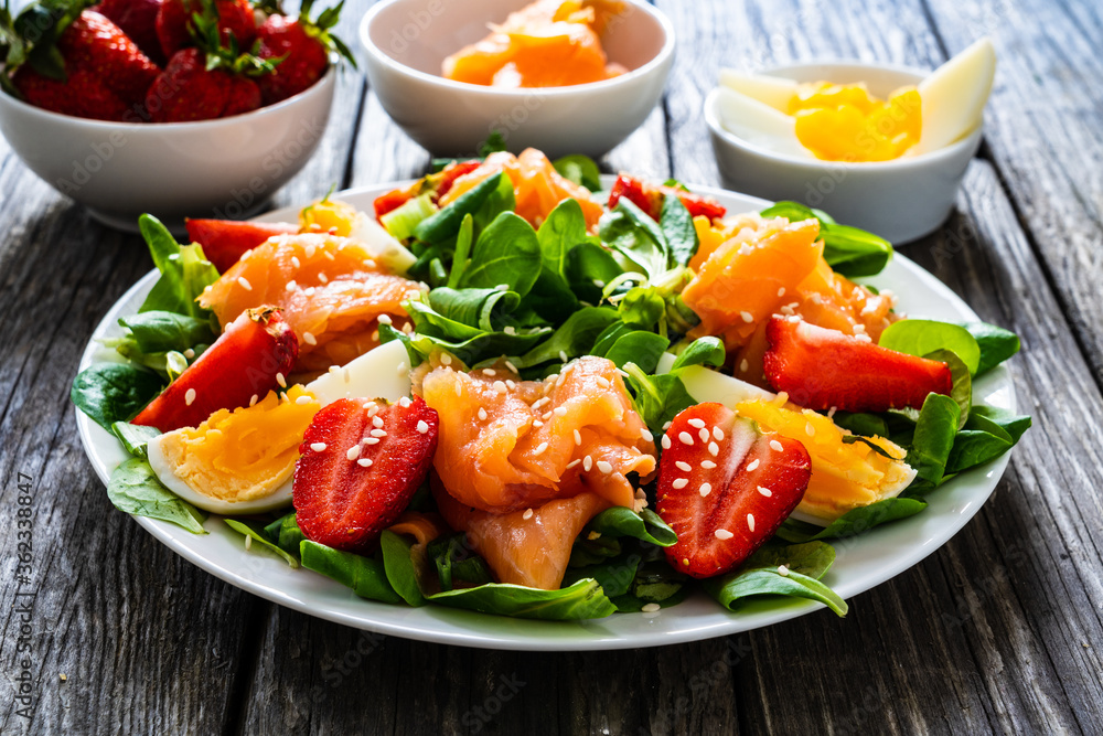 Salmon salad - smoked salmon boiled egg and vegetables on wooden background
Salmon salad - smoked salmon boiled egg and vegetables on wooden background