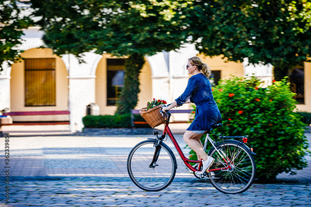 Urban biking - woman riding bike on city street
