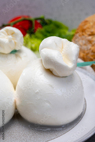 Cheese collection, fresh soft Italian cheese from Puglia, white balls of burrata or burratina cheese made from mozzarella and cream filling