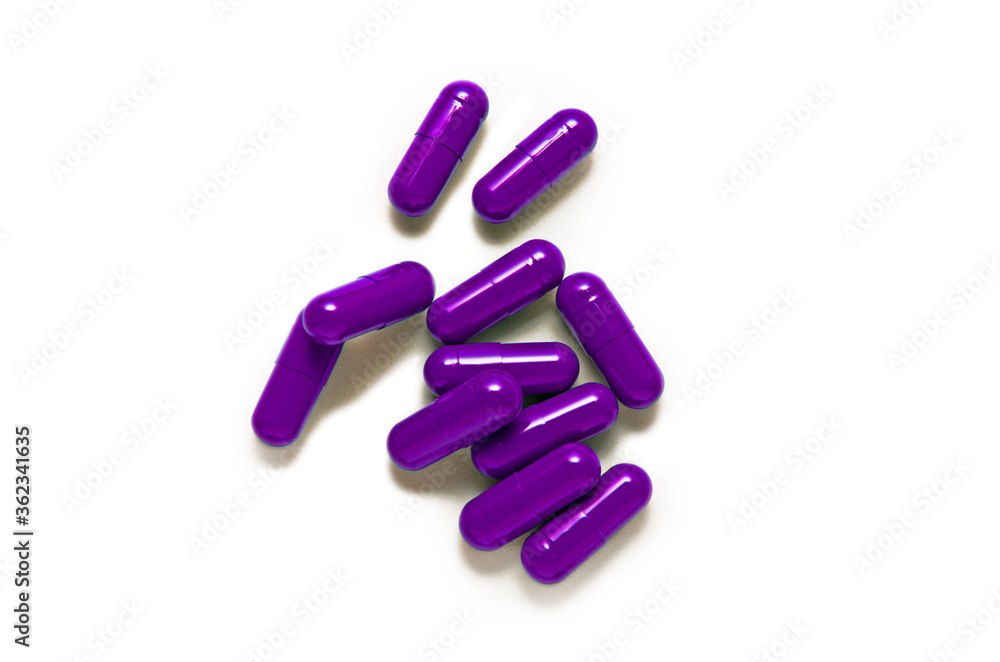 Purple capsule pills isolated on white background Purple capsule pills isolated on white background