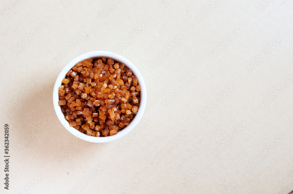 Bowl of Crystal Sugar isolated background, top view. Brown cane sugar. Bowl of Crystal Sugar isolated background, top view. Brown cane sugar.