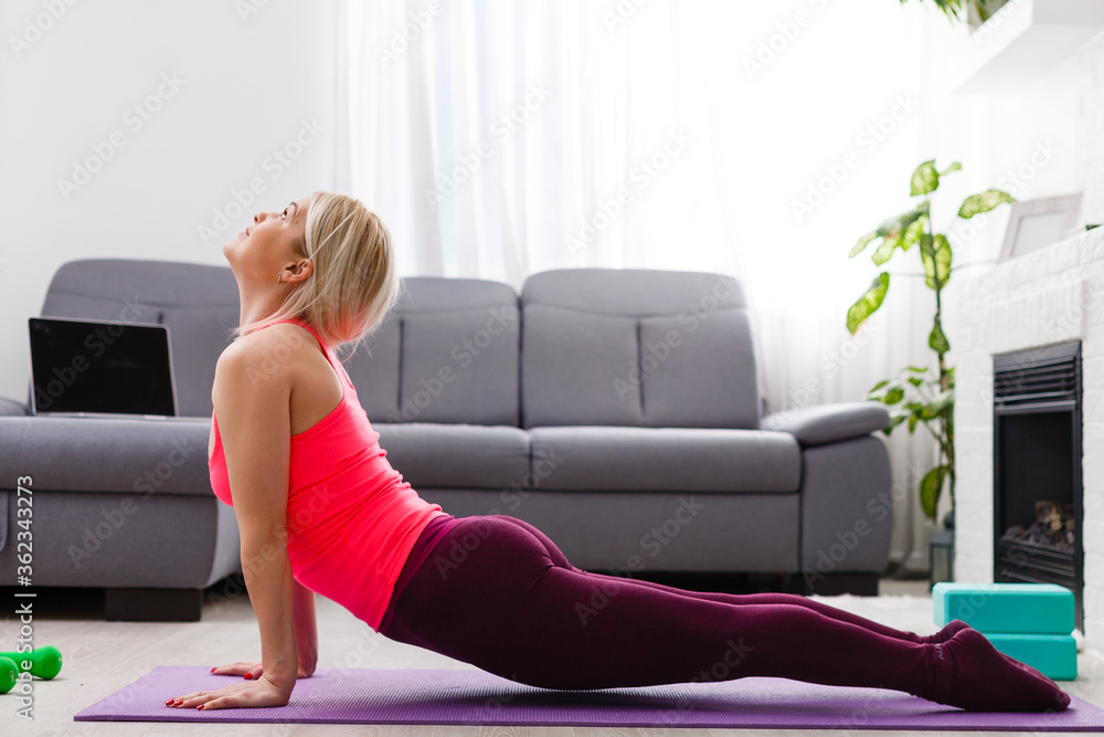 Fitness woman exercising on the floor at home