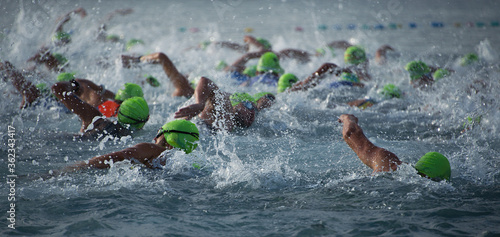 Competitors swimming out into open water at the beginning of triathlon photo