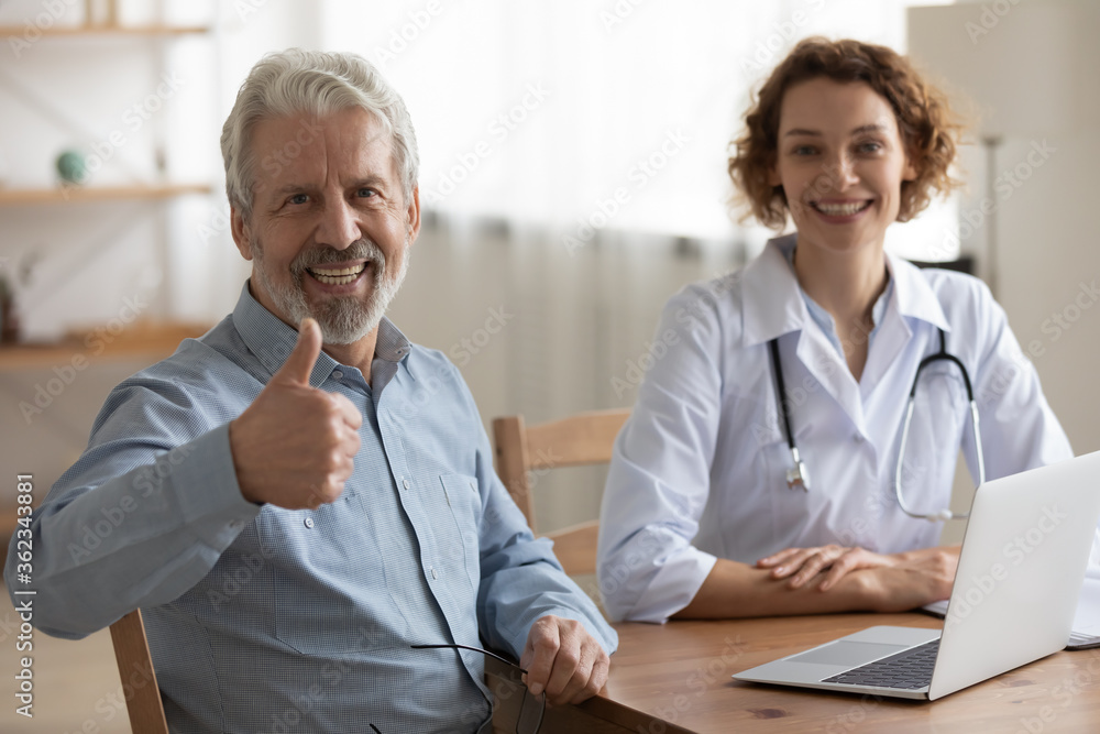 Fototapeta premium Smiling mature male patient show thumb up satisfied with good quality hospital medical service, portrait of happy senior man client recommend doctor or GP, recommendation, elderly healthcare concept