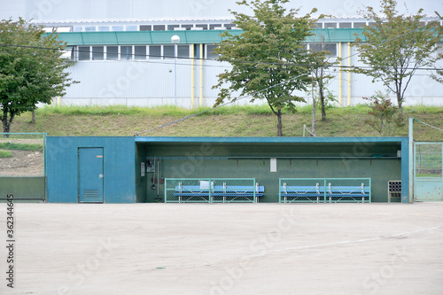 Empty bench of the suburban baseball field.

