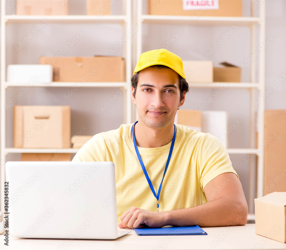 Handsome contractor working in box delivery relocation service Handsome contractor working in box delivery relocation service