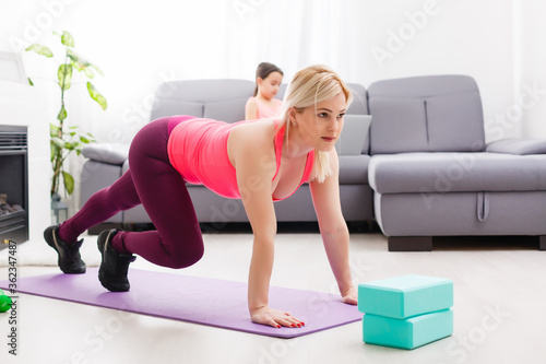 Fitness woman exercising on the floor at home