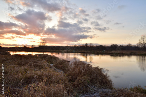 Sunset over a wide river on a cool spring day. Fish eye lens. © W Korczewski