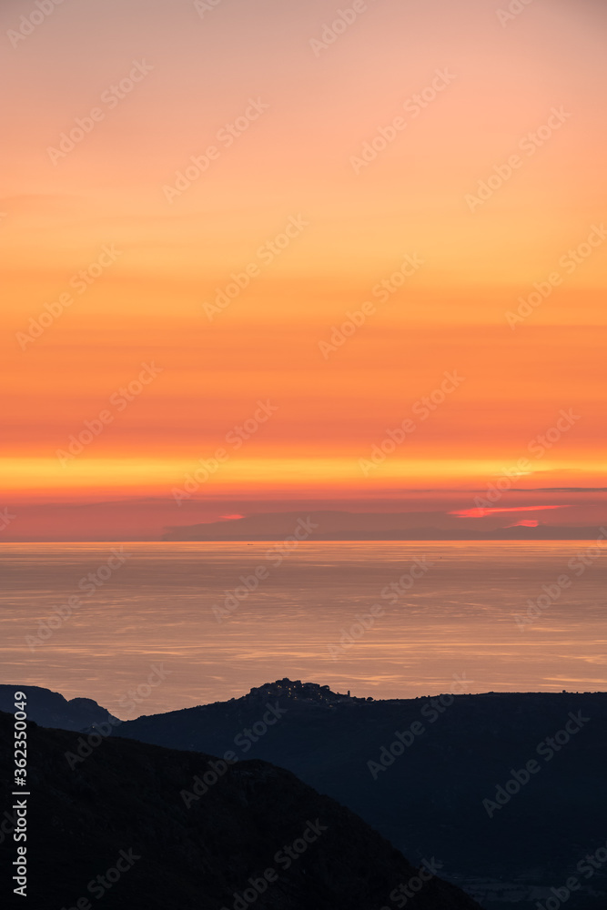 Sunset over the village of Sant'Antonino and Mediterranean Sunset over the village of Sant'Antonino and Mediterranean