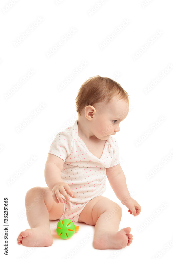 Cute baby girlsitting and playing with a rattle isolated on white background Cute baby girlsitting and playing with a rattle isolated on white background