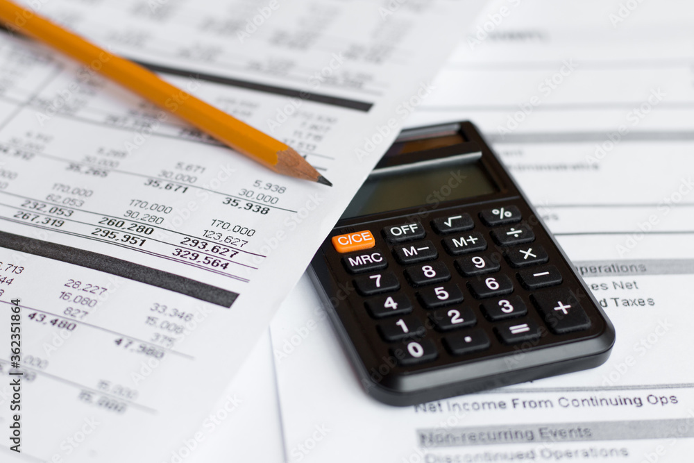 Financial Document with Pencil and Calculator Financial Document with Pencil and Calculator