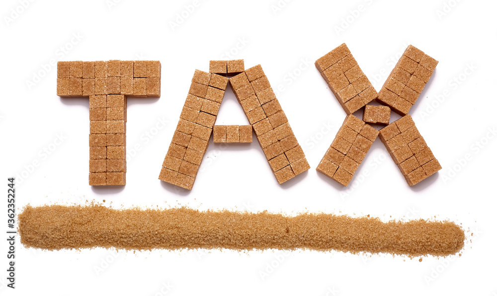 Cubes of brown sugar with grains of brown sugar underlining the word tax on a plain white background Cubes of brown sugar with grains of brown sugar underlining the word tax on a plain white background