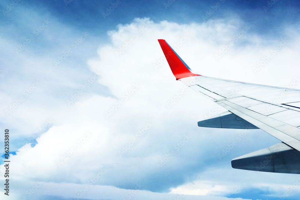 Fototapeta premium beautiful landscape view background of sky above cloud plane's window and see plane's wing