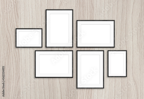 Photo frames set on wooden background, six realistic frameworks, interior decor mock up