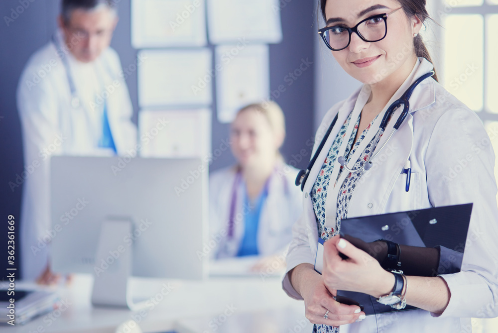 Woman doctor standing with stethoscope at hospital Woman doctor standing with stethoscope at hospital