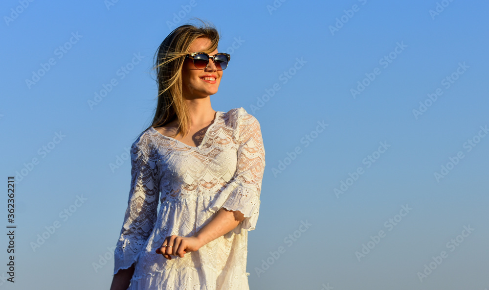 Emotional girl. Happy. Girl white dress feel free. Leisure and rest. Summer relax. Sunny day. Carefree girl. Pretty woman fashionable sunglasses outdoors. Girl blue sky background. Female health