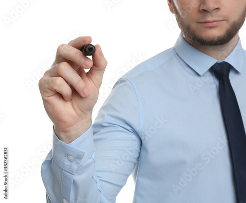 Businessman with marker against white background, focus on hand