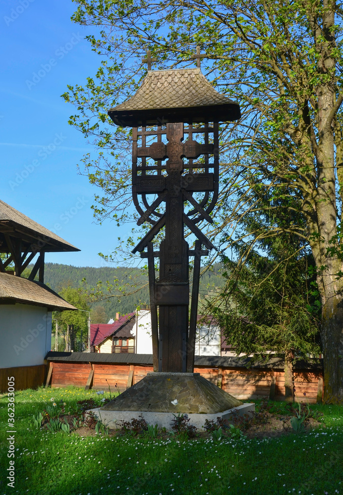HUMORULUI MONASTERY, BUCOVINA, ROMANIA, EUROPE, SPRING 2018. Wooden cross in the gardens of the Humor monastery