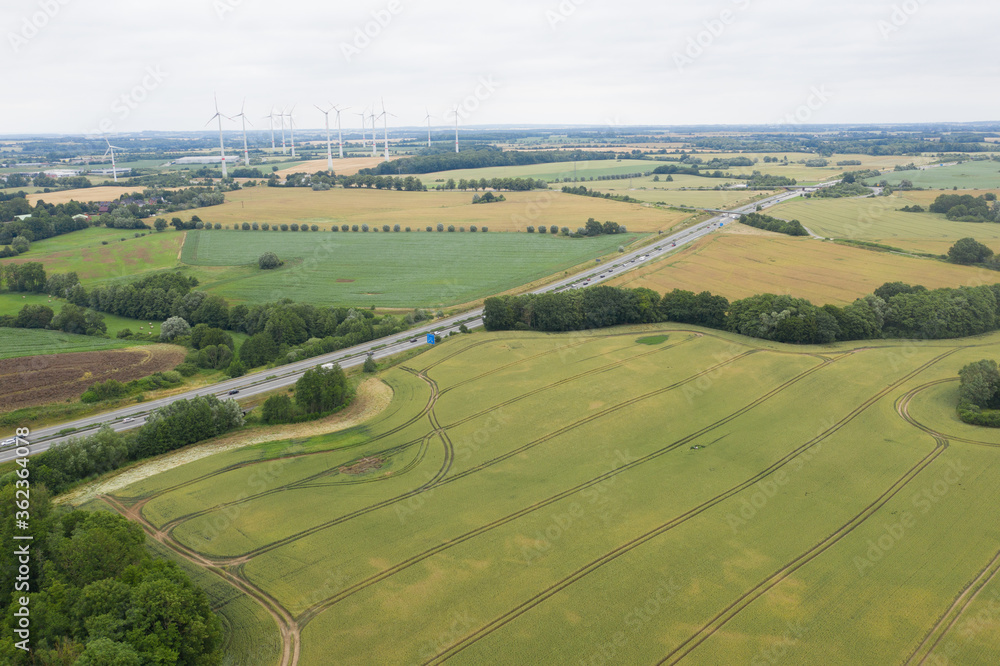  drone flies over the Mecklenburg landscape with its motorway and wind turbines