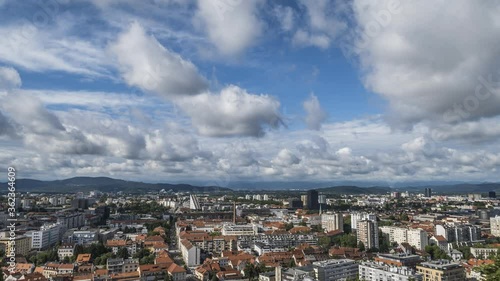 Ljubljana old town, Slovenia. Time lapse of white clouds moving over the city. Panoramic sky roof aerial view. Cityscape view from Ljubljana castle. Wide static shot