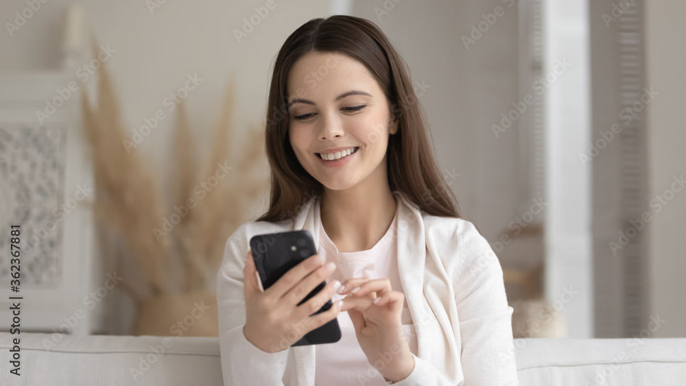 Close up smiling beautiful woman looking at smartphone screen, happy satisfied girl holding phone, chatting in social network, shopping online, browsing mobile device apps, searching information Close up smiling beautiful woman looking at smartphone screen, happy satisfied girl holding phone, chatting in social network, shopping online, browsing mobile device apps, searching information