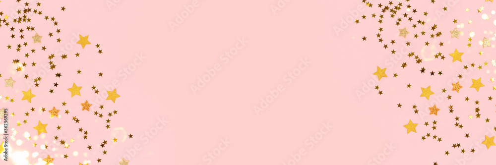 Frame made of gold stars confetti scattered on a pink pastel background. Banner with copy space. Frame made of gold stars confetti scattered on a pink pastel background. Banner with copy space.