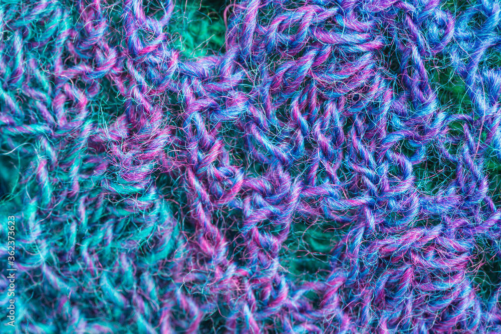 handmade multicolor crochet background in blue, green and purple with chain stitches and triple crochet stitches handmade multicolor crochet background in blue, green and purple with chain stitches and triple crochet stitches