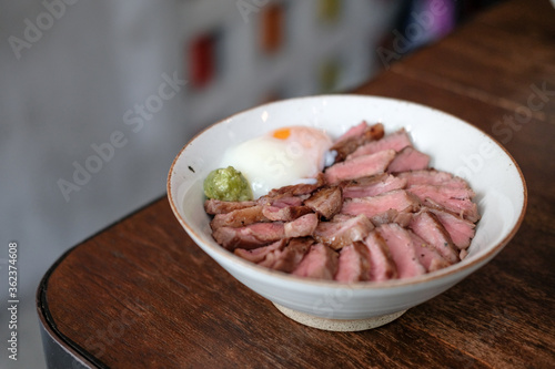 Steak Don, a Japanese dish consisting of a bowl of rice topped with rare beef with egg
