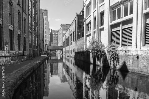 Post-industrial landscape of the Rochdale Canal as it runs through Manchester City Centre. Shot in black and white. 