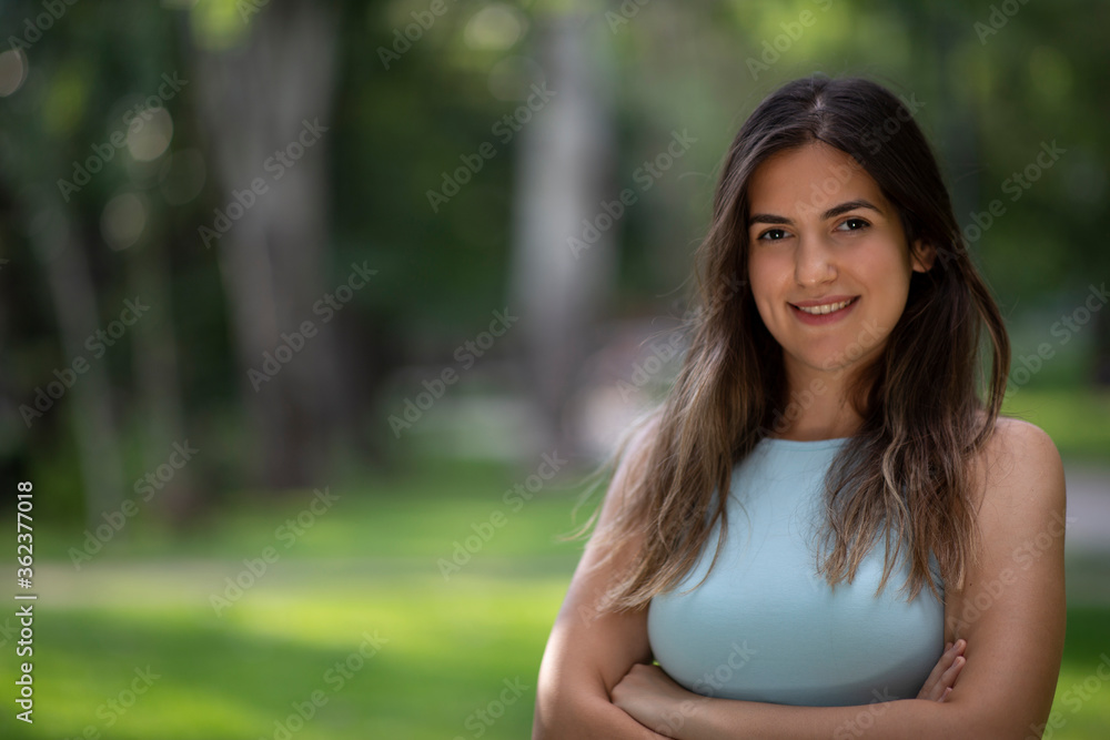 Beautiful Turkish young woman portrait with confident and warm smile at a city park Beautiful Turkish young woman portrait with confident and warm smile at a city park