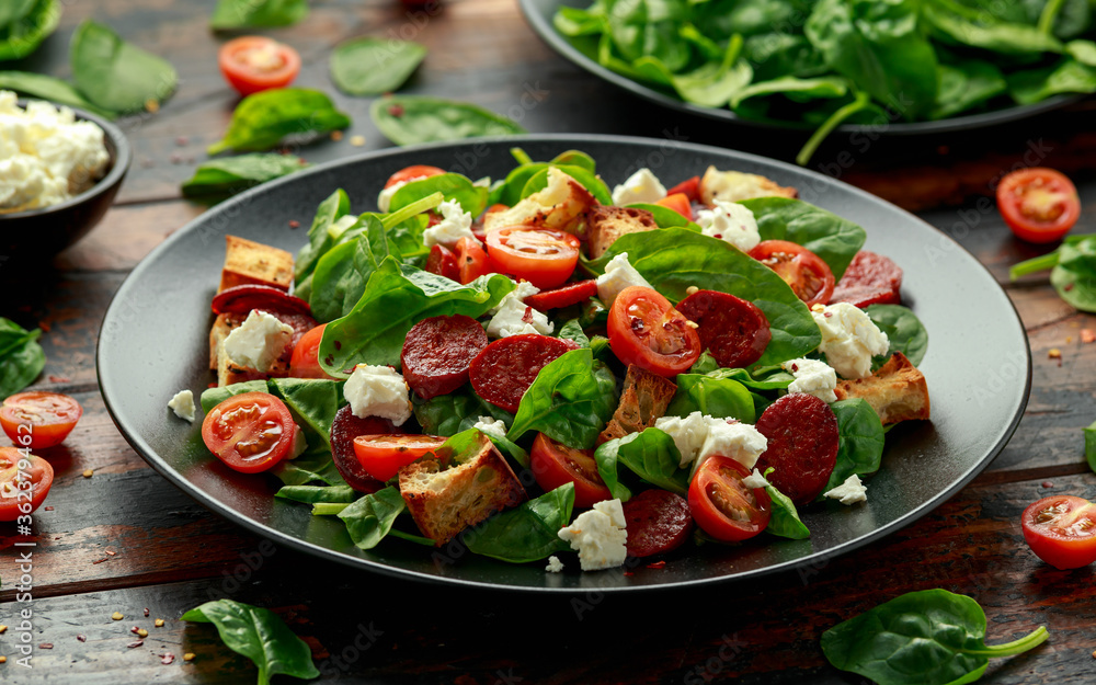 Chorizo Tomato salad with spinach, feta cheese and croutons. healthy summer food Chorizo Tomato salad with spinach, feta cheese and croutons. healthy summer food
