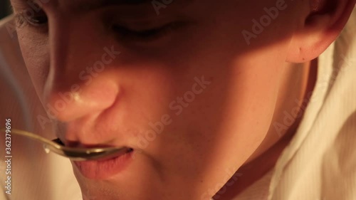 Wallpaper Mural Young guy eating cottage cheese with a spoon, macro view Torontodigital.ca