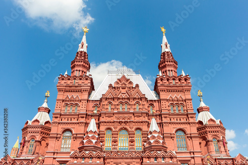 View towards State Historical Museum on Red Square on a summer morning. Clear blue sky with few clouds. Blurred yellow line leads to museum. Theme of travel in Russia.