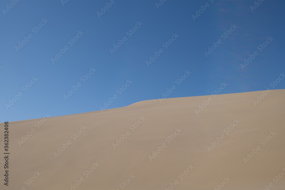 sand dune under blue sky. abstract and simplicity. At Dunhuang, Gansu province, China sand dune under blue sky. abstract and simplicity. At Dunhuang, Gansu province, China