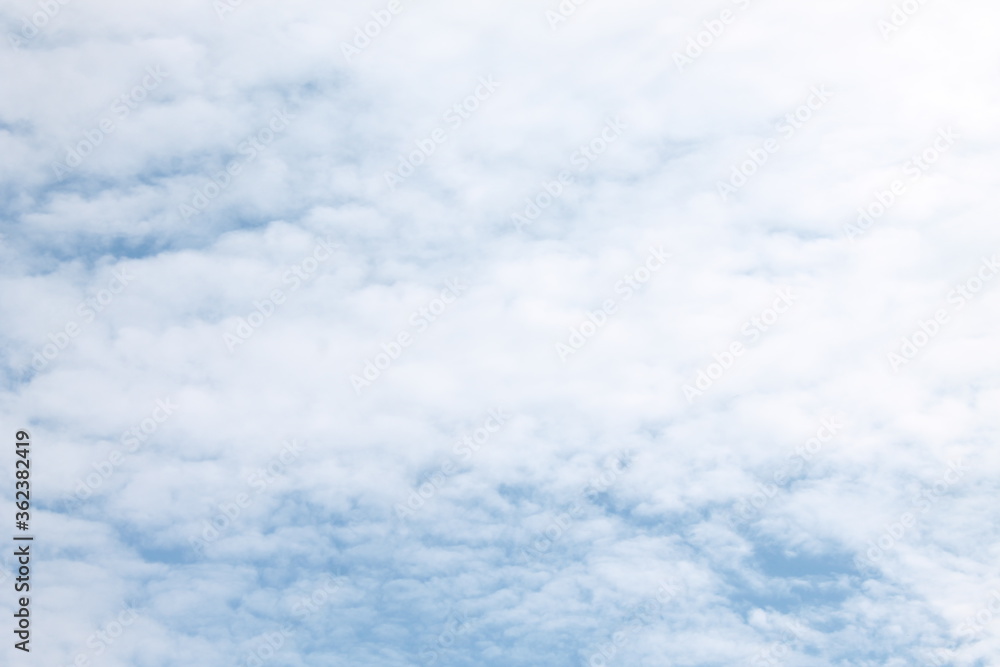 Summer sky filled with white wispy clouds with very little blue showing through