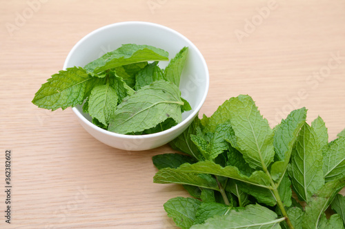 Collection of fresh mint leaves,on wooden table