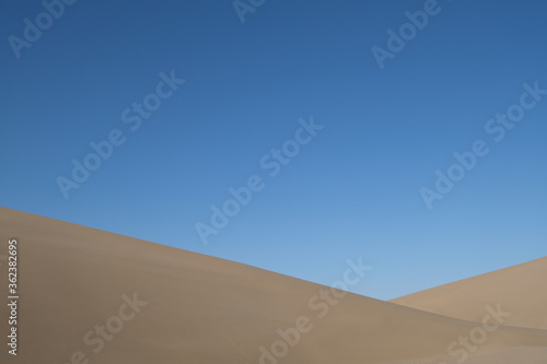 sand dunes under blue sky. abstract and simplicity. At Dunhuang, Gansu province, China