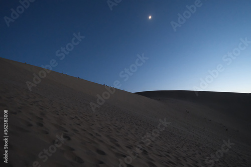 Fototapeta Naklejka Na Ścianę i Meble -  sand dunes and blue skyline at night.low angle. At Dunhuang,Gansu province,China