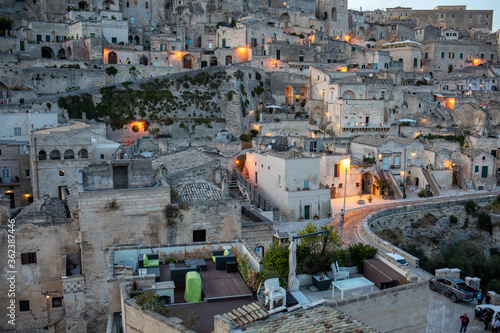 Evening view of the city of Matera; Italy; with the colorful lights highlighting old buildings in the Sassi di Matera a historic district in the city of Matera. Basilicata. Italy