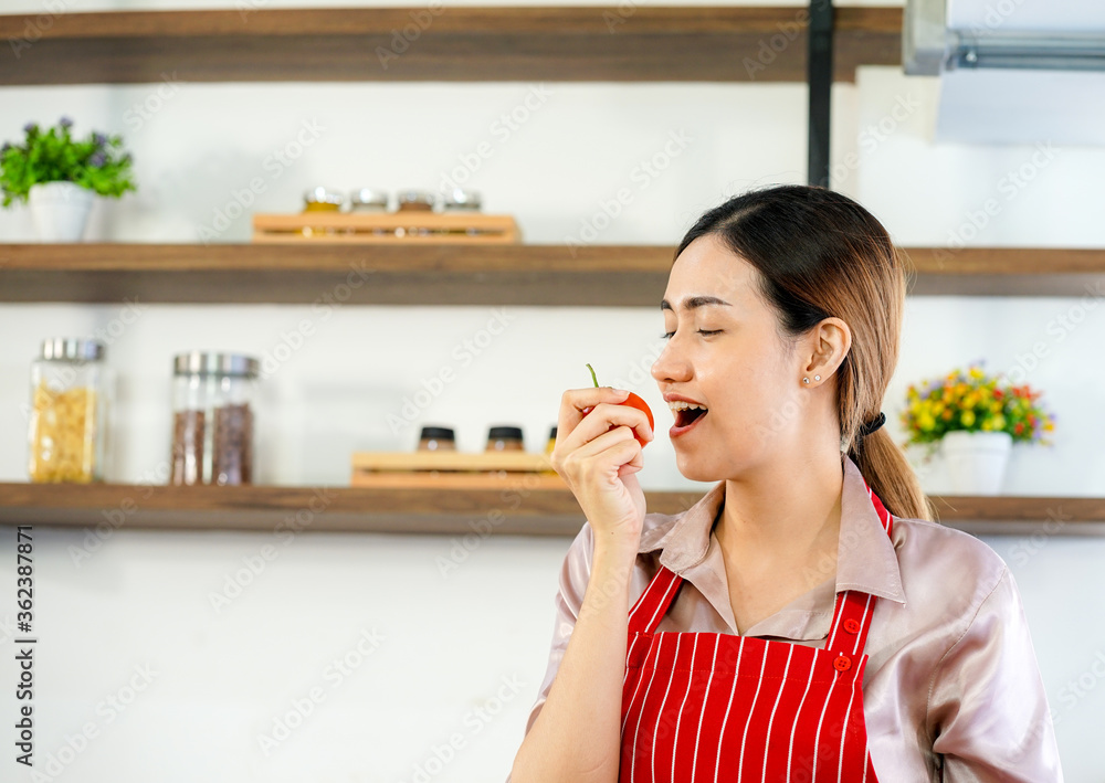 young attractive Asian woman recording cooking lesson online live streaming vlogger in the kitchen. Work from home concept. social media influencer concept. young attractive Asian woman recording cooking lesson online live streaming vlogger in the kitchen. Work from home concept. social media influencer concept.