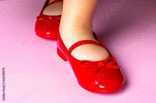 Kid girl in red shoes, fashion style. Horizontal