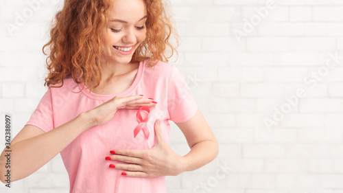 Red-Haired Girl Framing Pink Ribbon Symbol Posing, White Background, Panorama