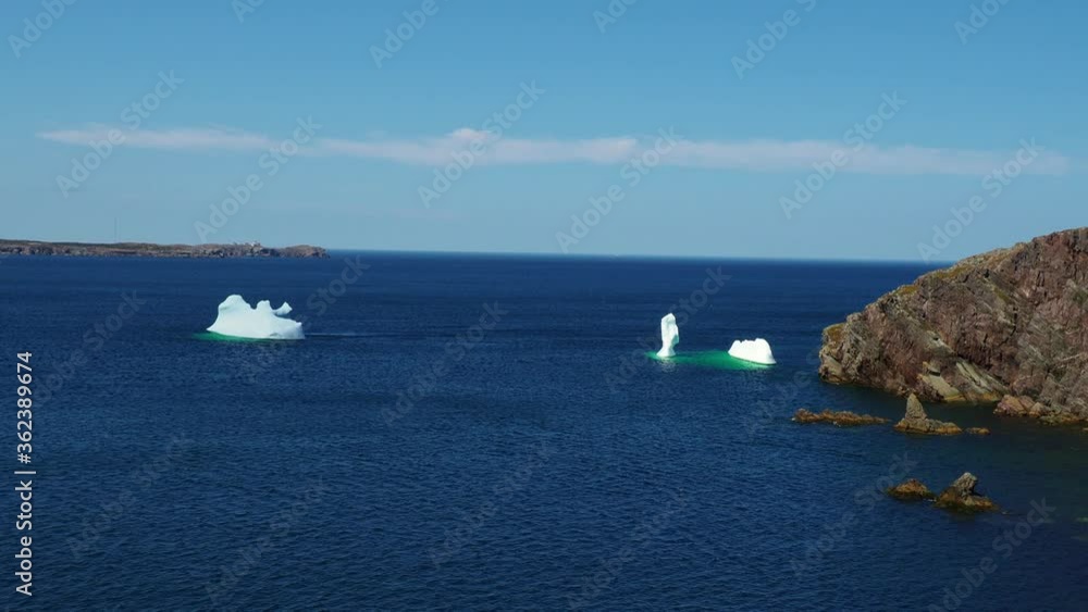 An iceberg grounded Bonavista, Newfoundland, showing the beauty of the coastline in summer. Very popular with tourist. An iceberg grounded Bonavista, Newfoundland, showing the beauty of the coastline in summer. Very popular with tourist.