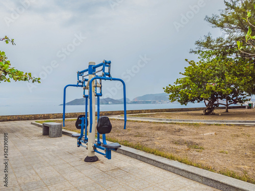Free workout fitness street exercise machines equipment in empty public city park. Longevity, physical strength exercises, push ups alone for Covid 19 prevention. Healthy lifestyle in quarantine