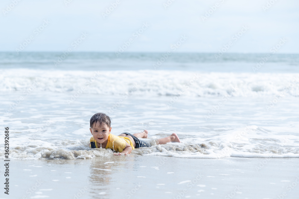 Little boy playing and splashing in sea waves Little boy playing and splashing in sea waves