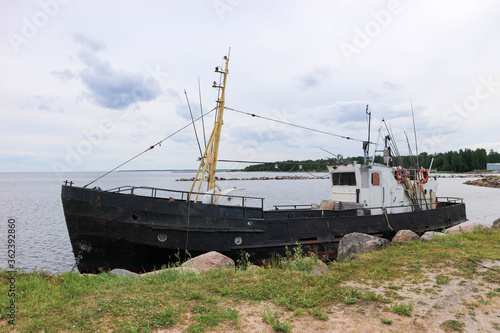 Wallpaper Mural old abandoned fishing boat stuck in the stones Torontodigital.ca