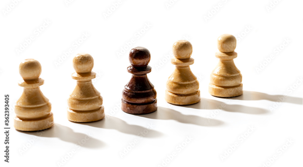 One black chess pawn among whites. Concept of racism and discrimination. One black chess pawn among whites. Concept of racism and discrimination.
